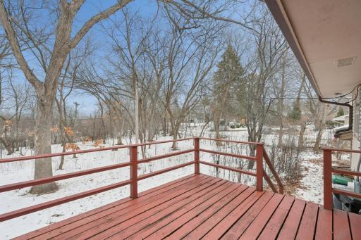 Deck from kitchen overlooks backyard