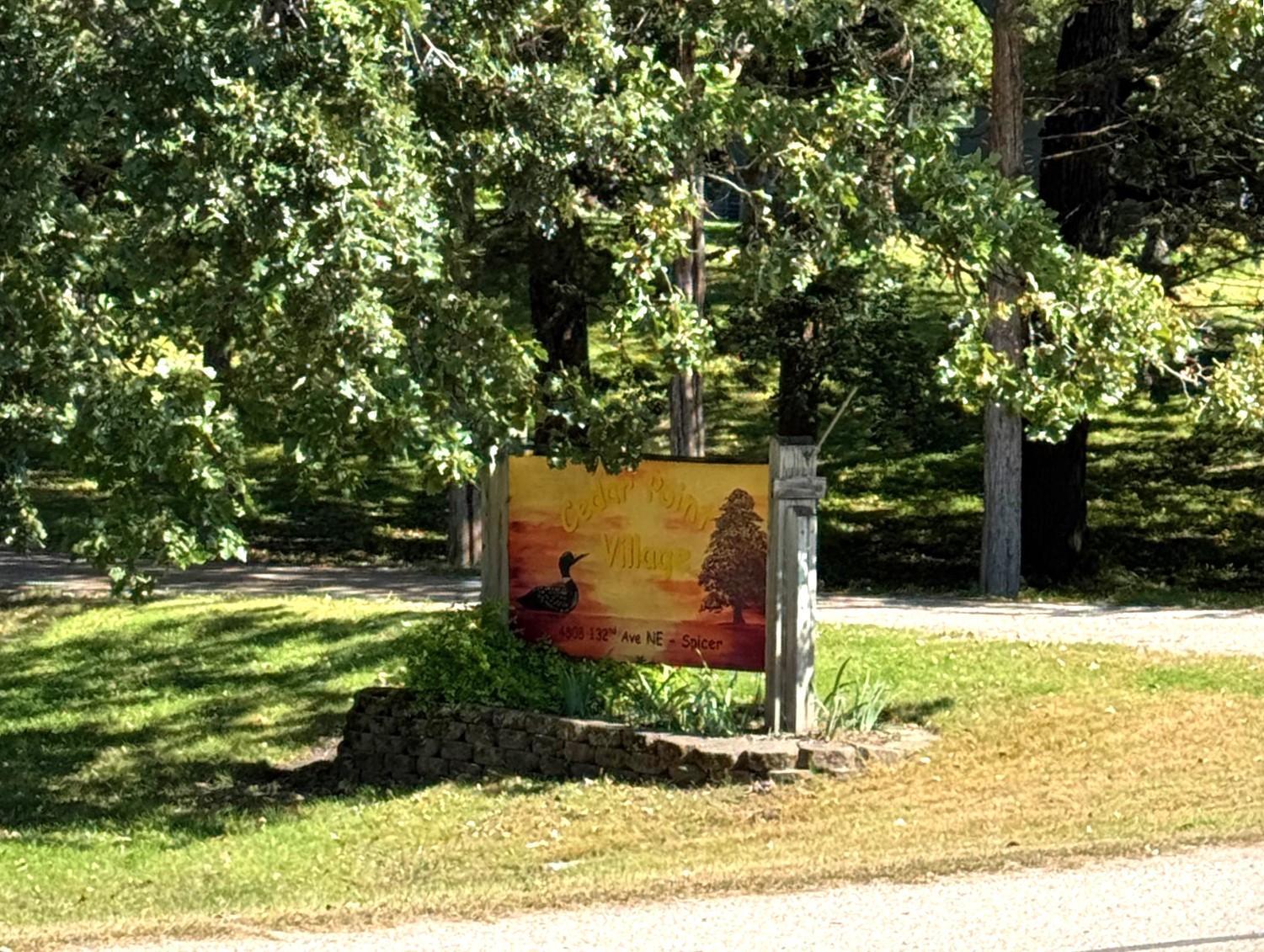 Cedar Point Village sign by road