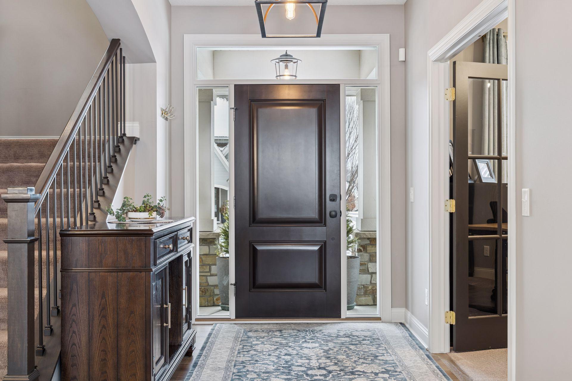 The 2 story foyer with french doors to home office.