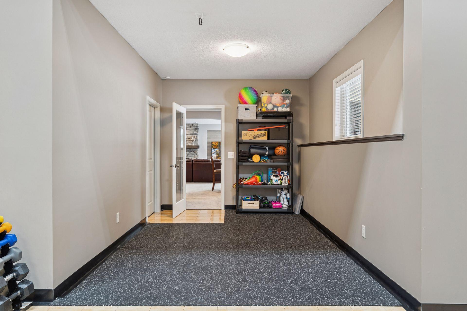 Exercise room with rubber floor just off the home gym.