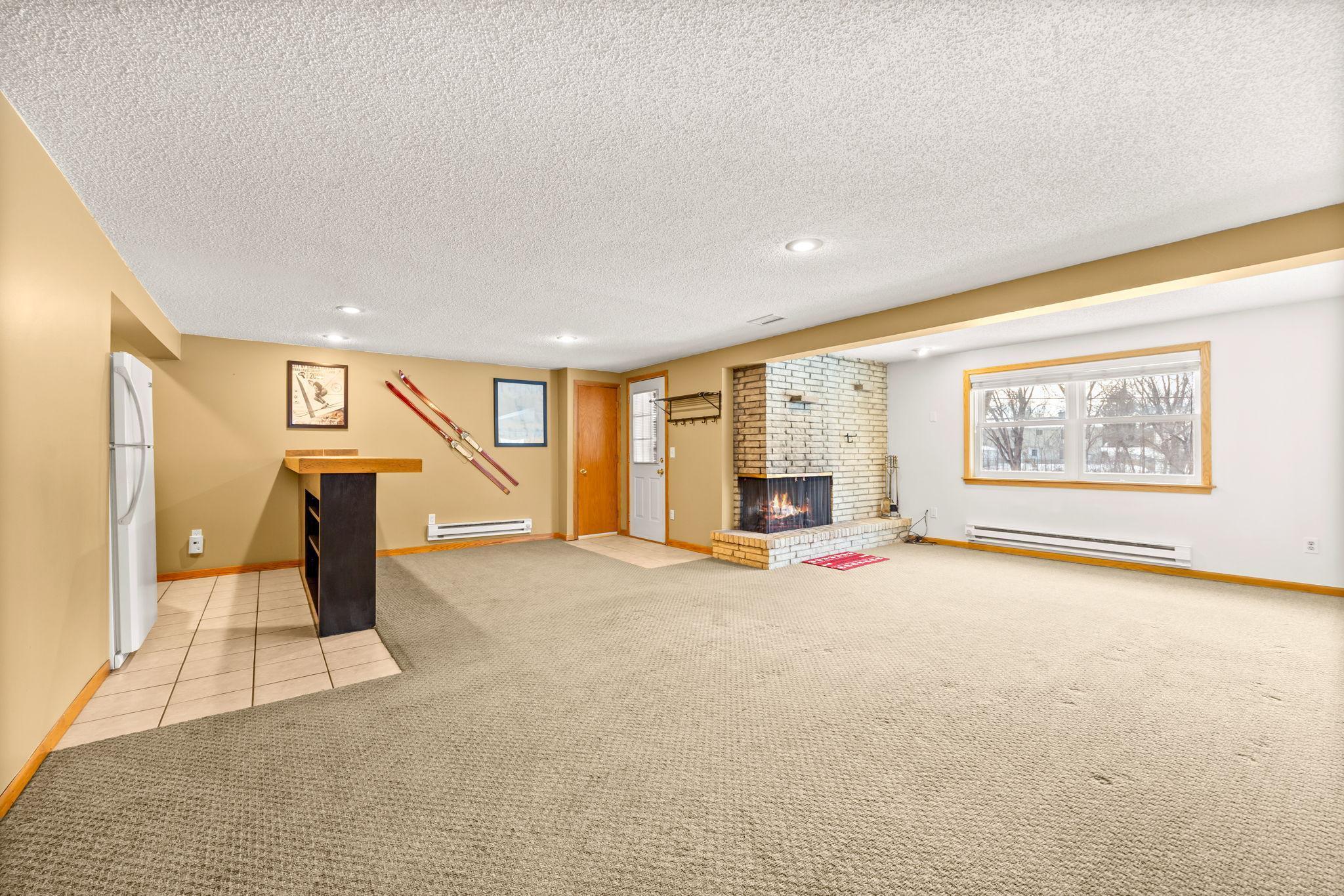 This large family room with bar greets you in the walk-out lower level.