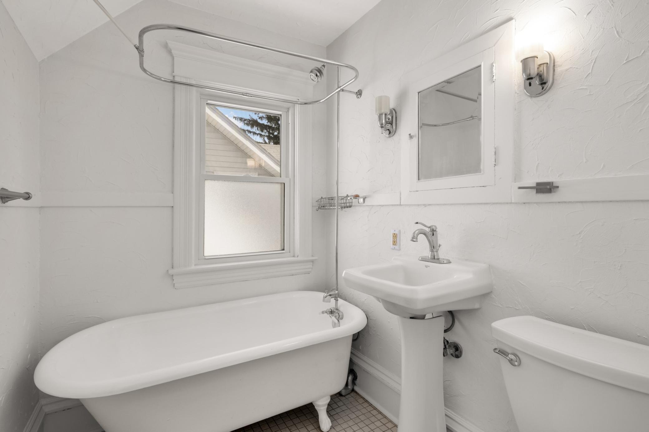 Upper level full bathroom with clawfoot tub and shower.