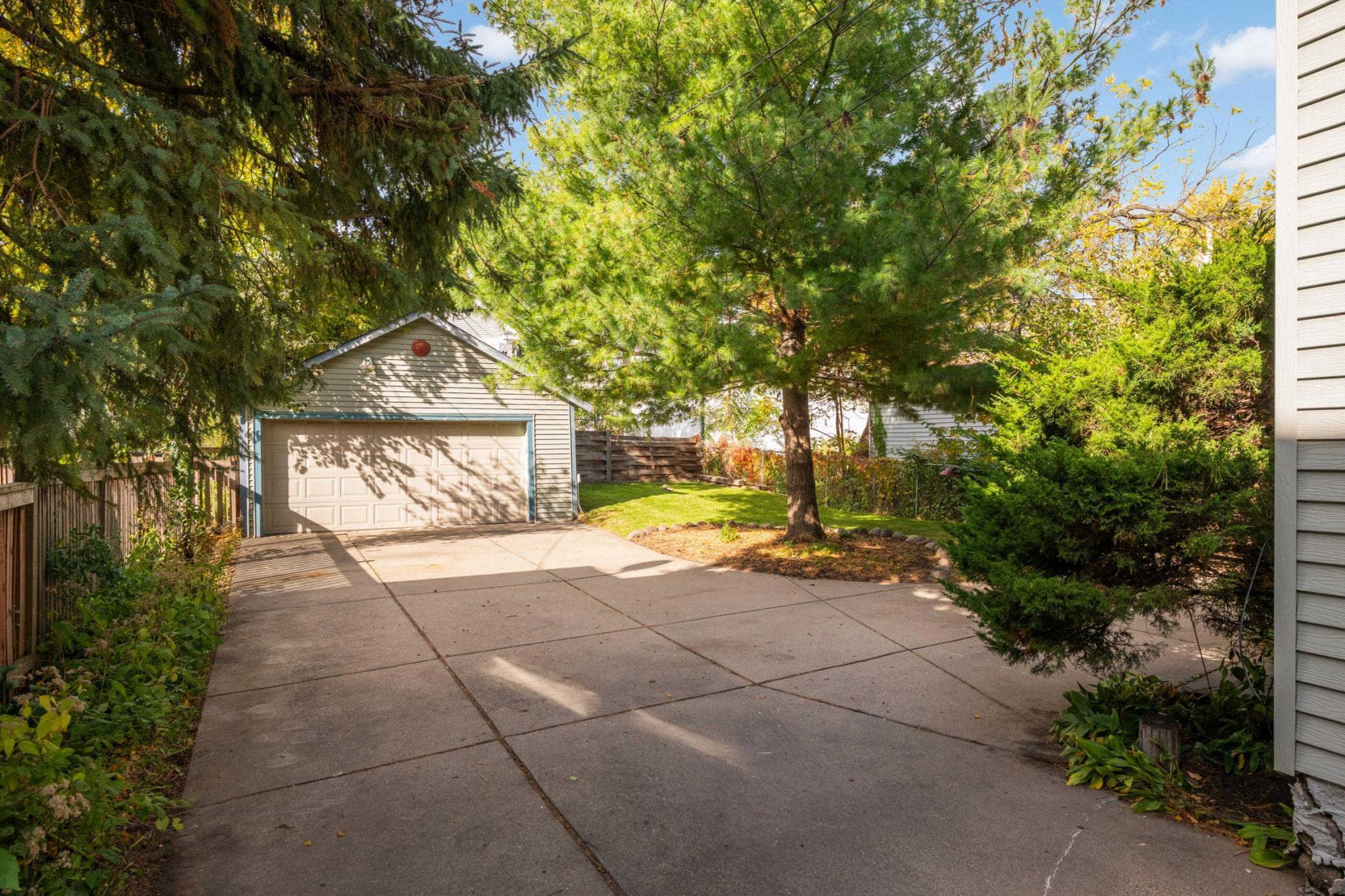 Concrete driveway is designed to be able to turn around and drive out forward to Lyndale Ave.