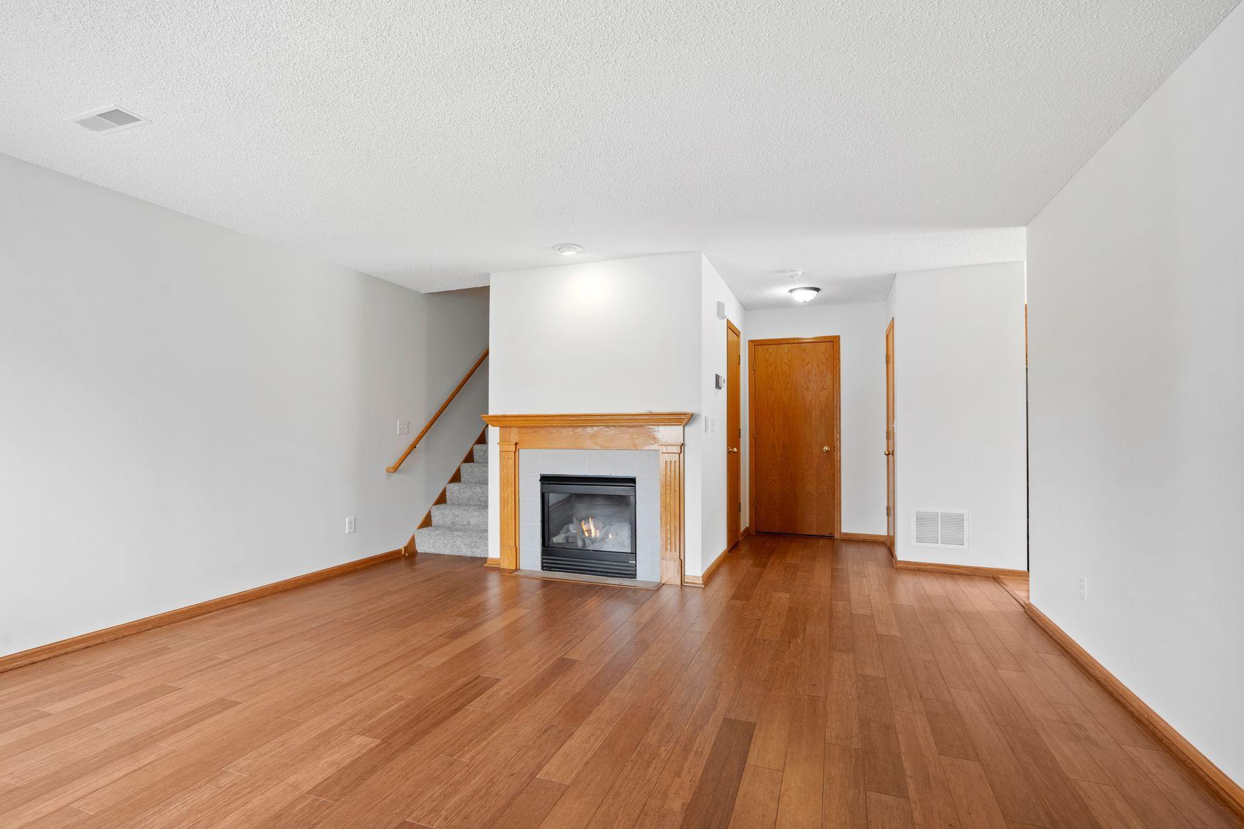 Large living area with gas fireplace. Beautifiul flooring