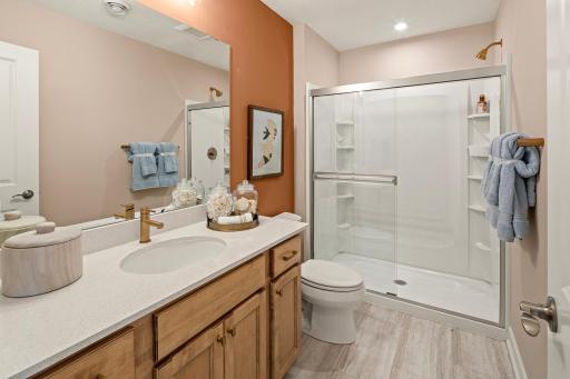Thoughtfully designed lower level bathroom with a spacious vanity and a layout that feels simple and efficient *photo of model home (design options may vary)