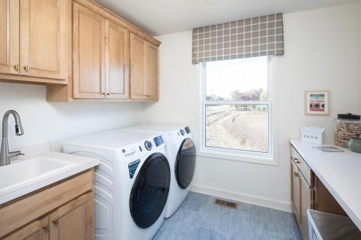 Laundry day feels lighter here with a clean setup, great storage, and space that keeps everything moving smoothly *photo of model home (design options may vary)