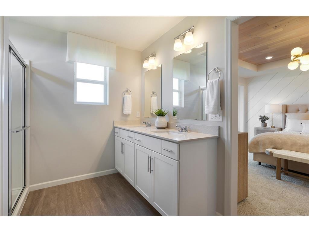 Dual sinks with quartz countertops in owner's bathroom