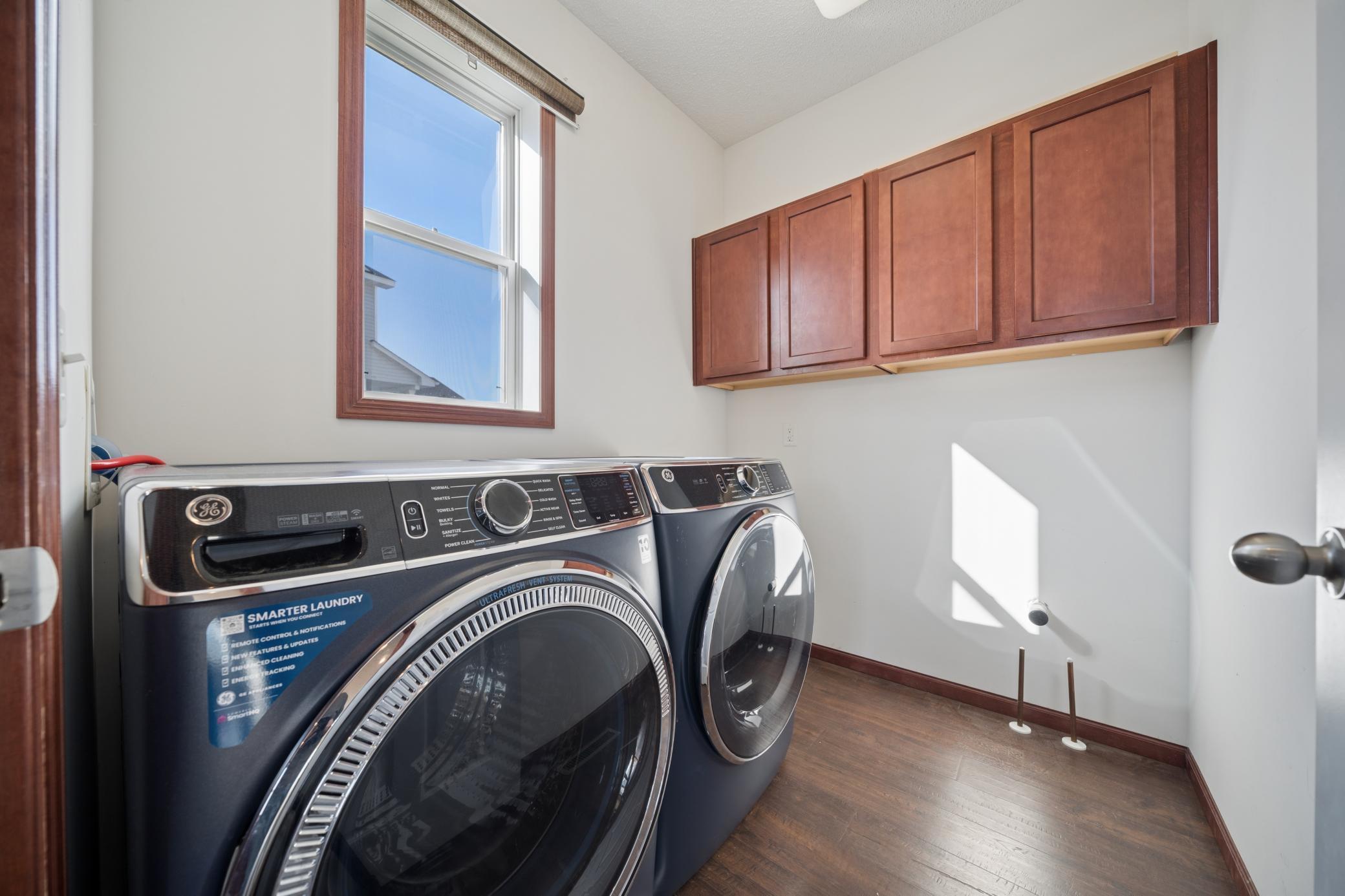 Main floor laundry room with front loading washer and dryer