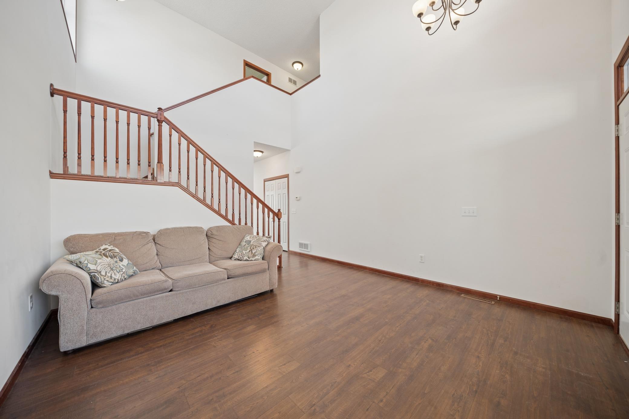 Soaring two story foyer and living room