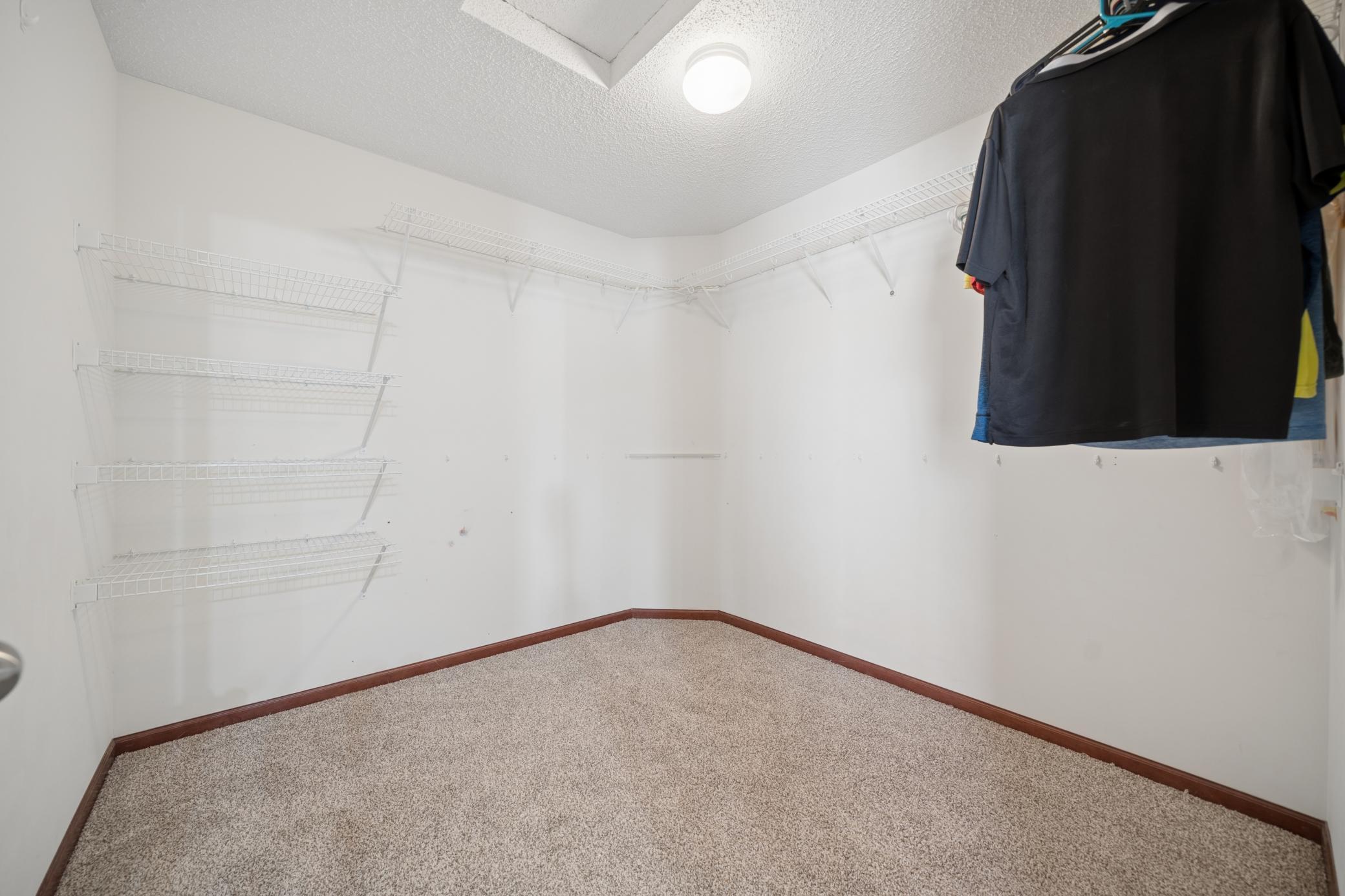 Primary bedroom's generously sized walk-in closet