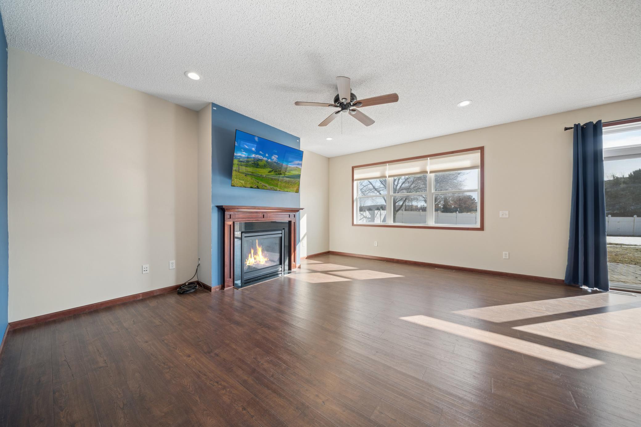 Main floor family room with an abundance of sunshine and cozy gas fireplace