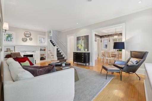 Living room to dining room view with fresh interior paint, recessed lighting, marble-surround fireplace, hardwood floors throughout.