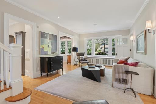 Beveled glass accent on front picture window, sconce lighting and airy spaces for your family.