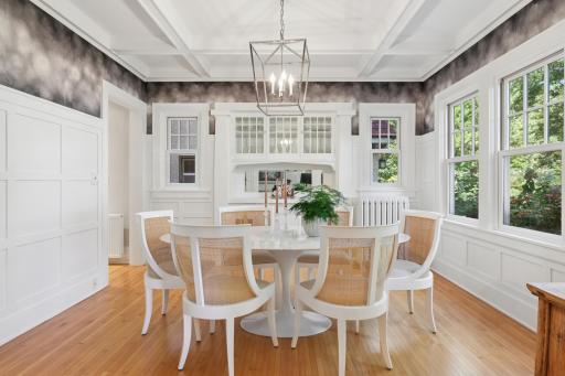 Impressive dining room with wainscoting, box-beamed ceiling, original built-in hutch for serving.