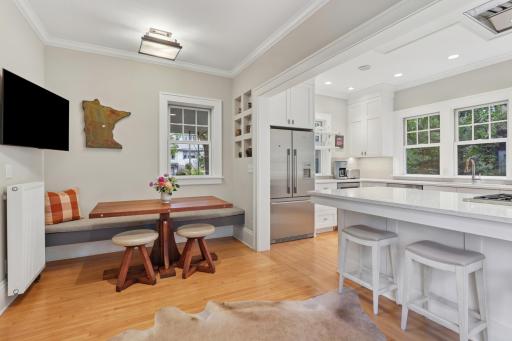 Renovated kitchen with quartz breakfast bar, updated appliances, eat-in dining nook area.