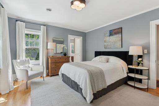 Upper level with hardwood floors, four bedrooms and this primary suite with private 3/4 bath and two walk-in closets with California Closet organizers.