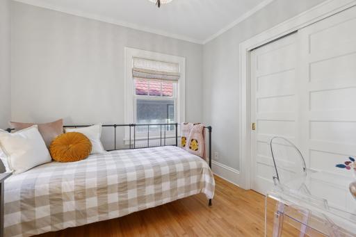 4th bedroom on upper level, with two closets (one a walk-in closet with built-in dresser).