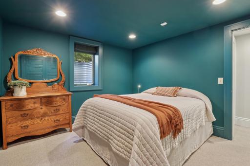 5th bedroom in the lower level with high ceilings, just around the corner from the 3/4 bath for convenience.