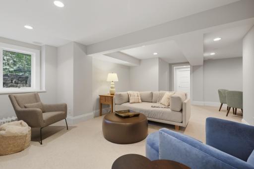 Lower level family room with bonus seating area and egress window to let in the light, in-floor radiant heat.