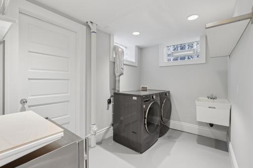 Lower level laundry area with bonus walk-in closet for storage, another beverage fridge.