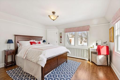 Sunlight fills the space, highlighting a versatile bedroom that easily doubles as a quiet home office