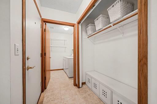 Convenient laundry room and closet off the hall by the garage door