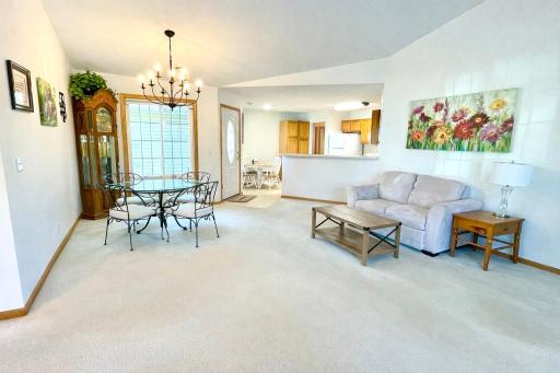 living room and dining area with a lovely chandelier *Photo taken before move-out