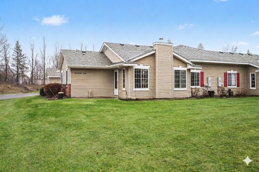 This quad townhome has lots of green space out the sunroom windows.png