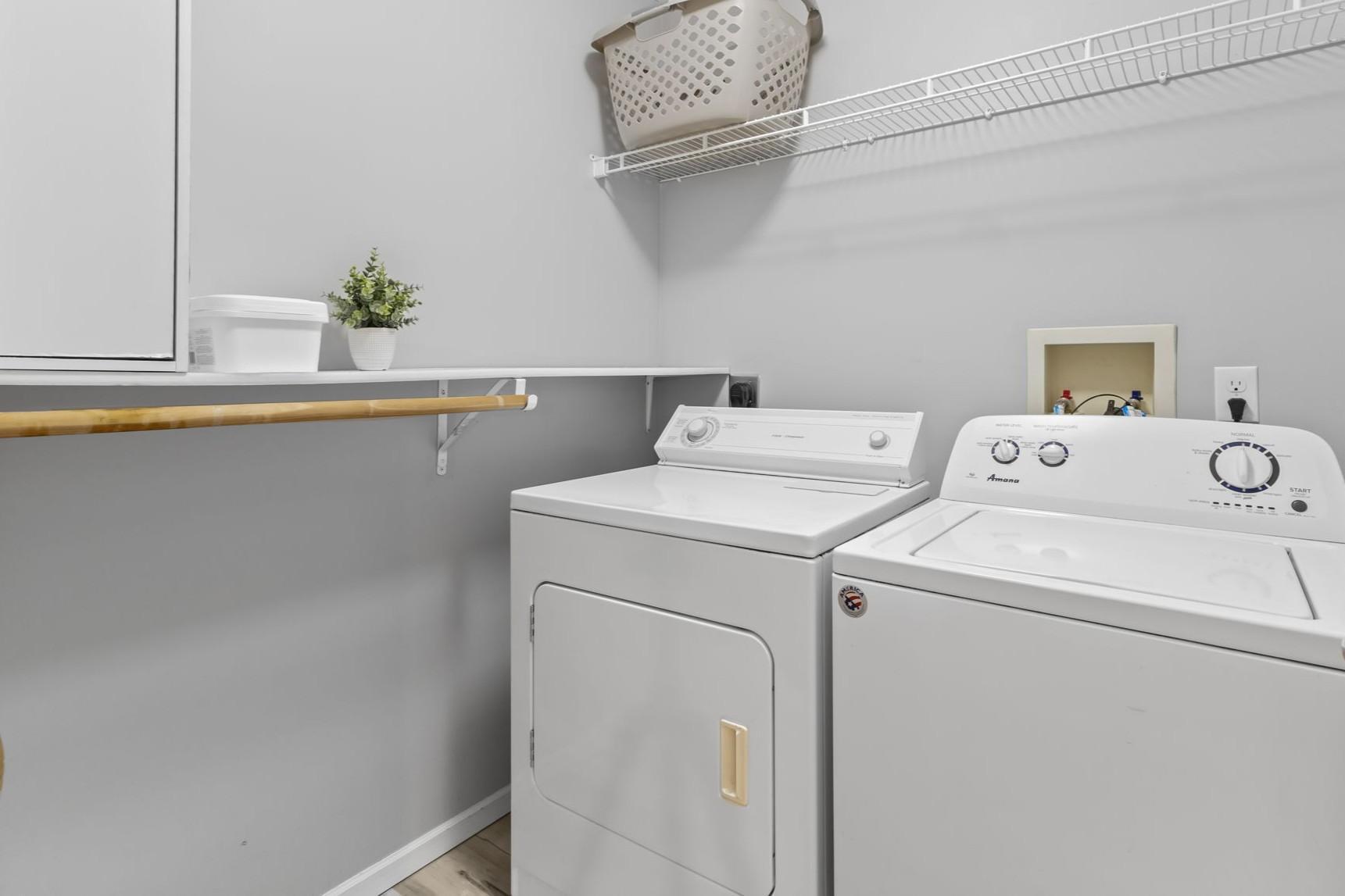 A dedicated laundry room is conveniently located on the second floor between the bathroom and loft area.
