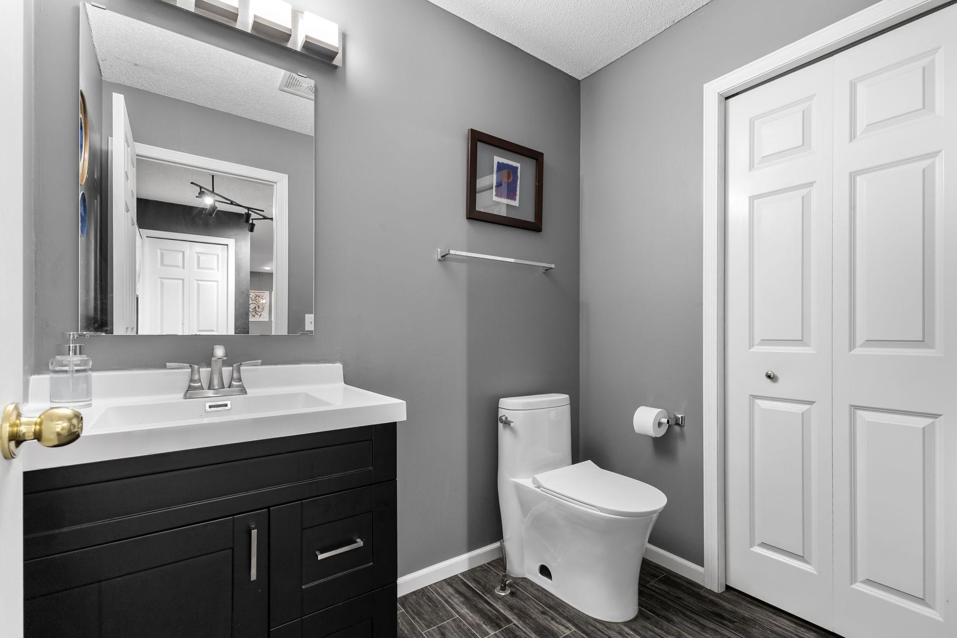 An updated half bath with access to the mechanical room rounds out the first floor.