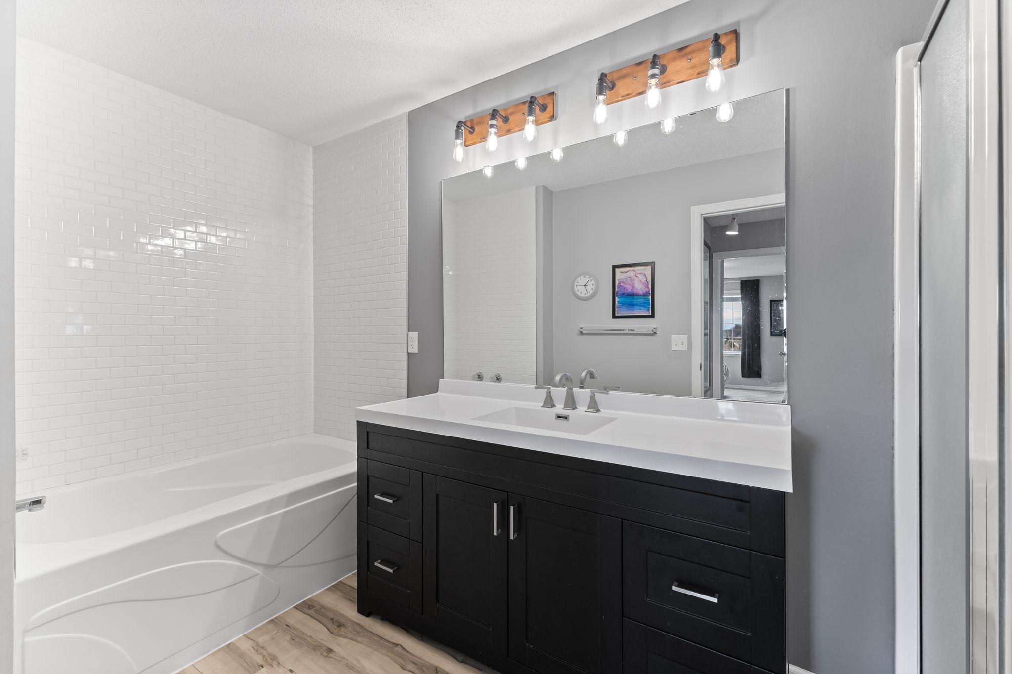 The shared full bathroom has been updated, and features a newer vanity with soft-close drawers and cabinets.
