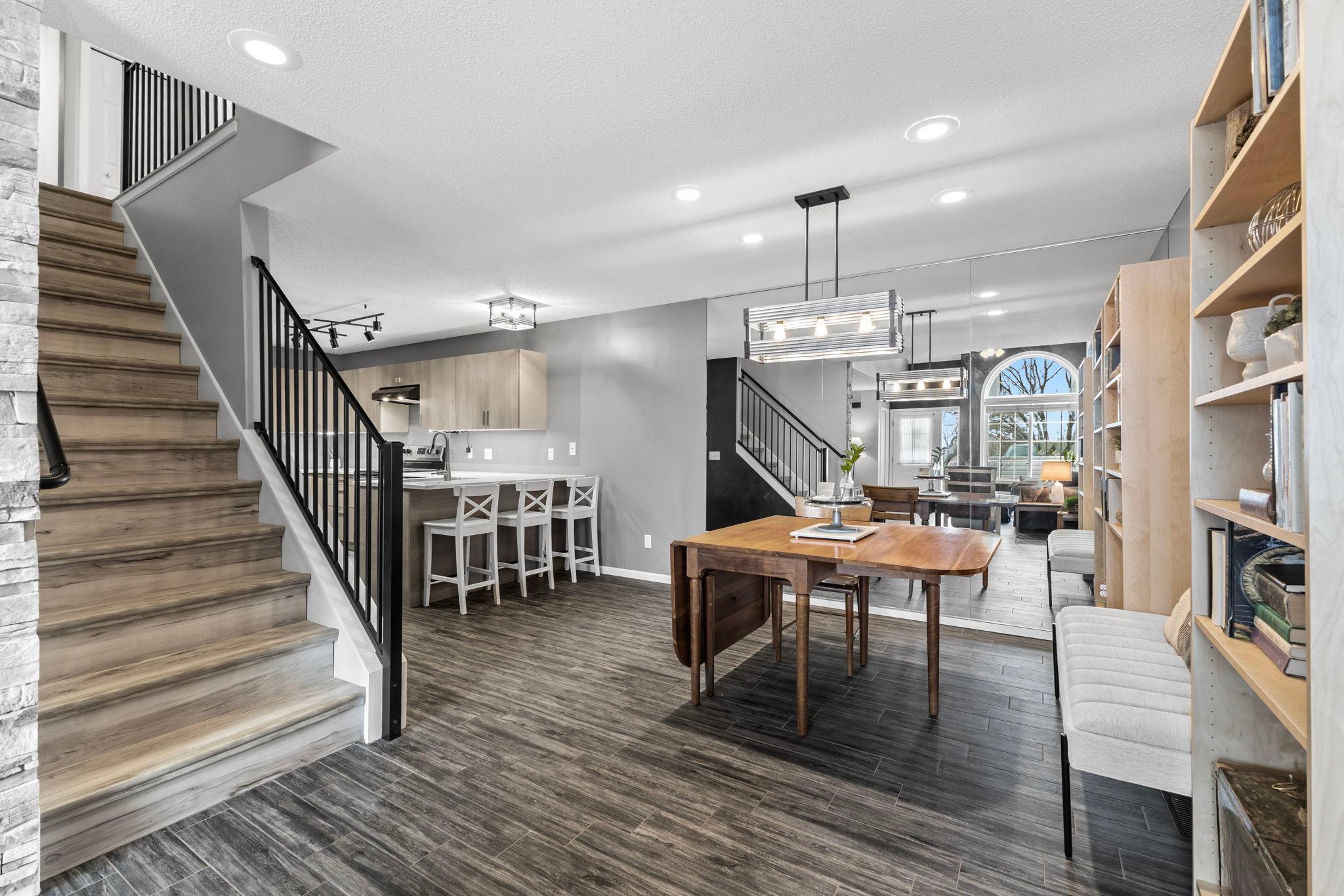 The casual dining area space for a large table, and a large mirror to reflect the townhome's natural light.