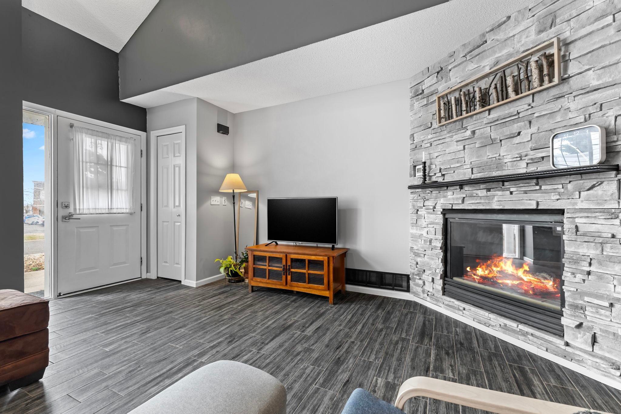 The main floor features a stunning grey wood-look ceramic tile plank floor.