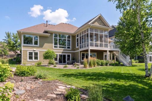 Back of home with patio and water feature