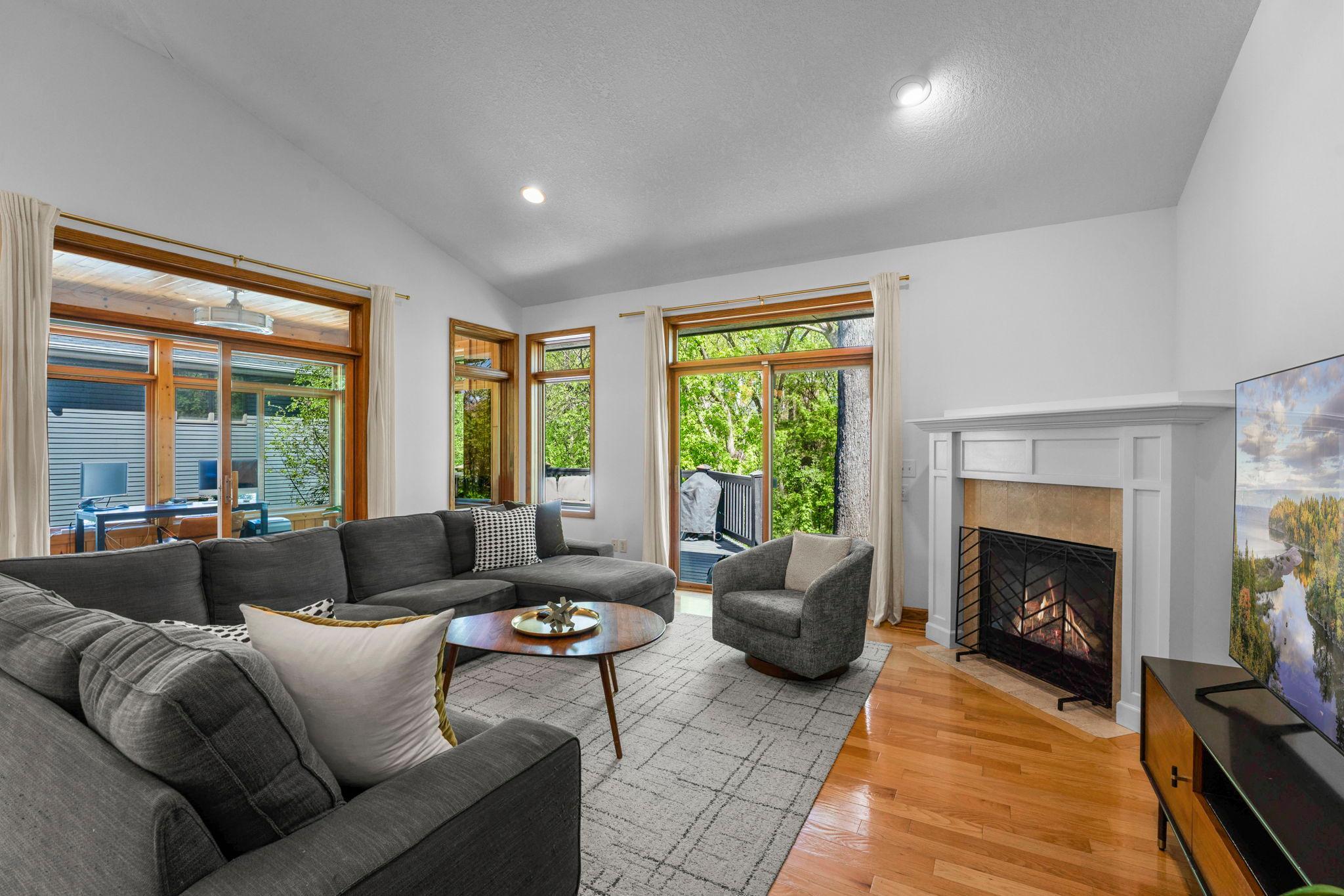 Windows on the woods and a gas fireplace frames the living area!