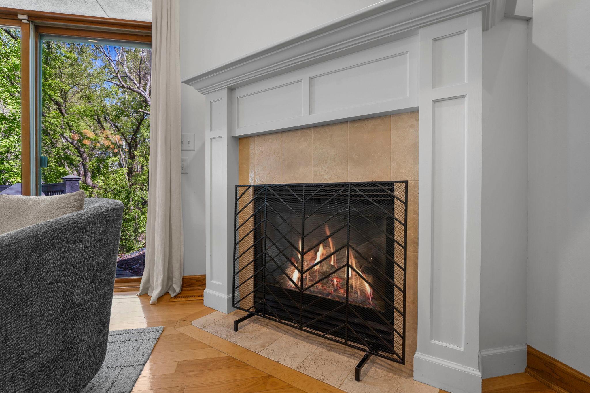 Windows on the woods and a gas fireplace frames the living area!