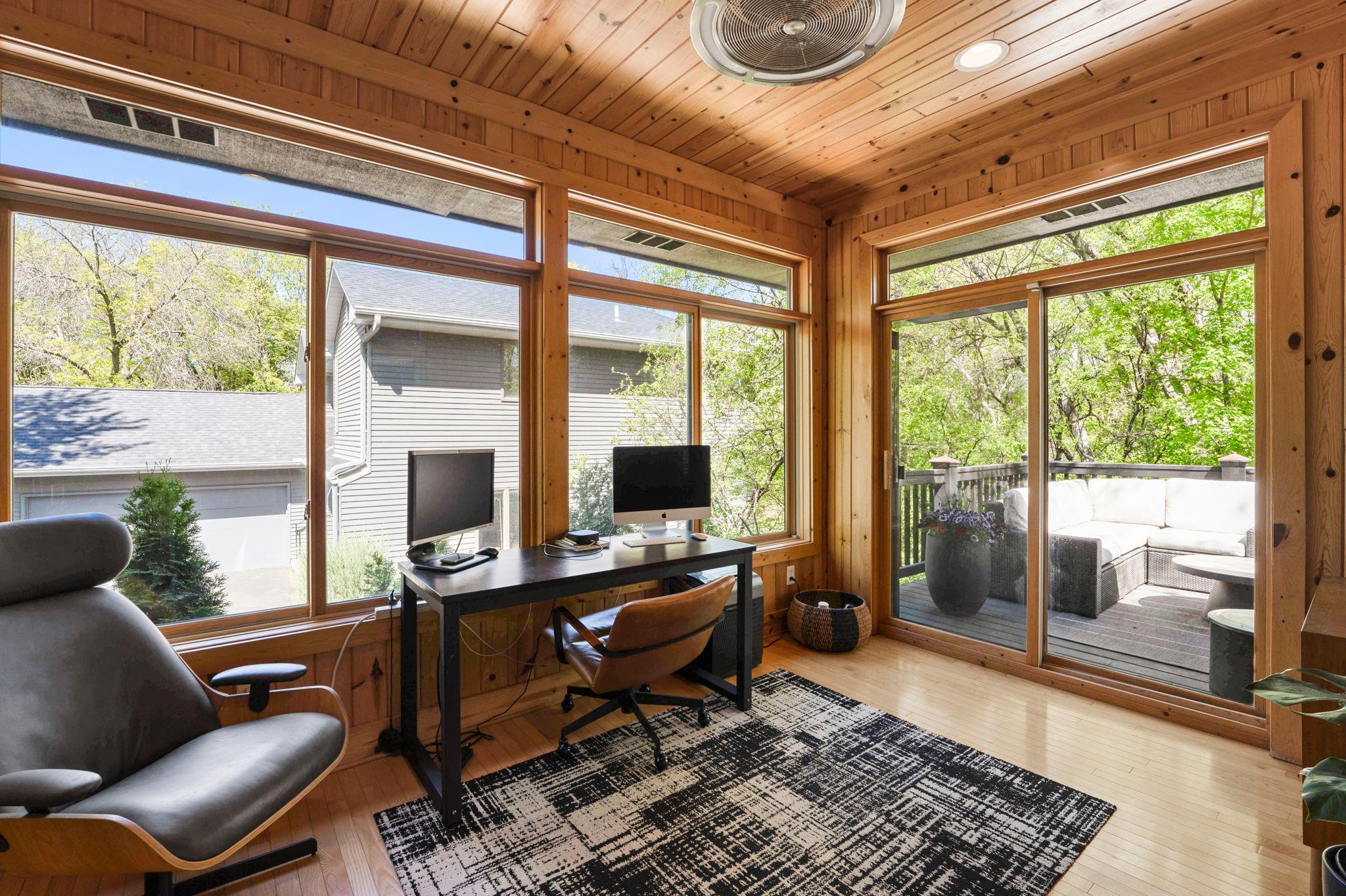 Main floor also features sunroom or "3 season porch" , though currently used year round as an office. Sliding doors to the back deck.