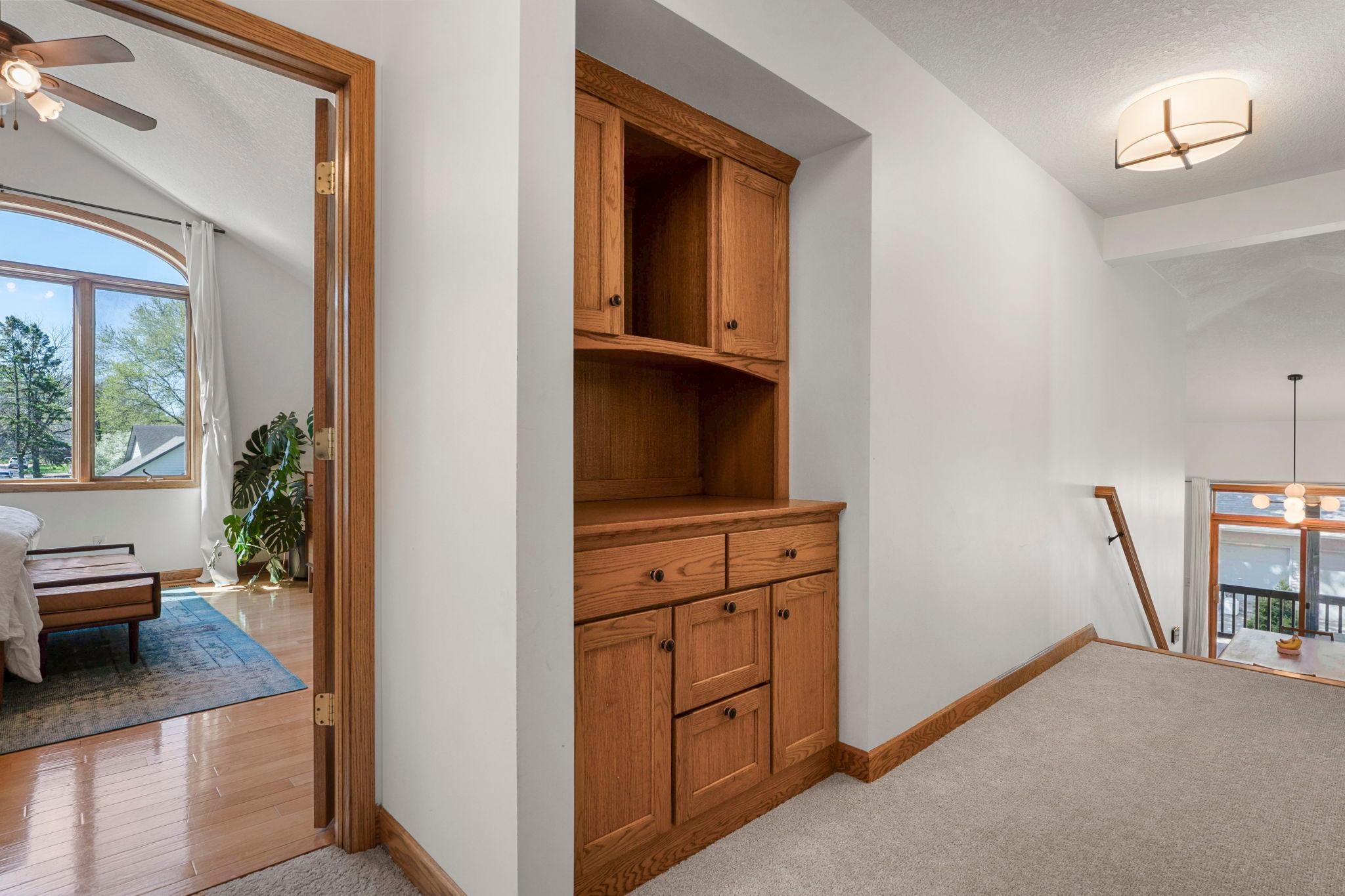 Hallway off primary features a built in and additional closet space. New carpet upstairs as well as updated lighting!