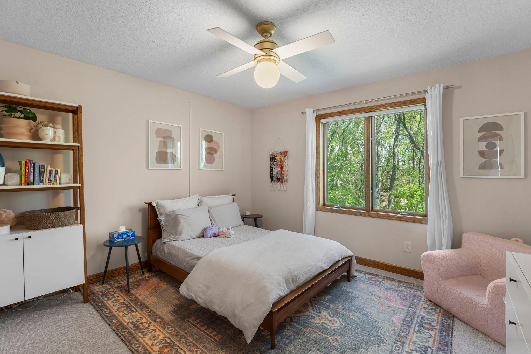 Another of the 3 bedrooms up, featuring a window on the woods and walk in closet