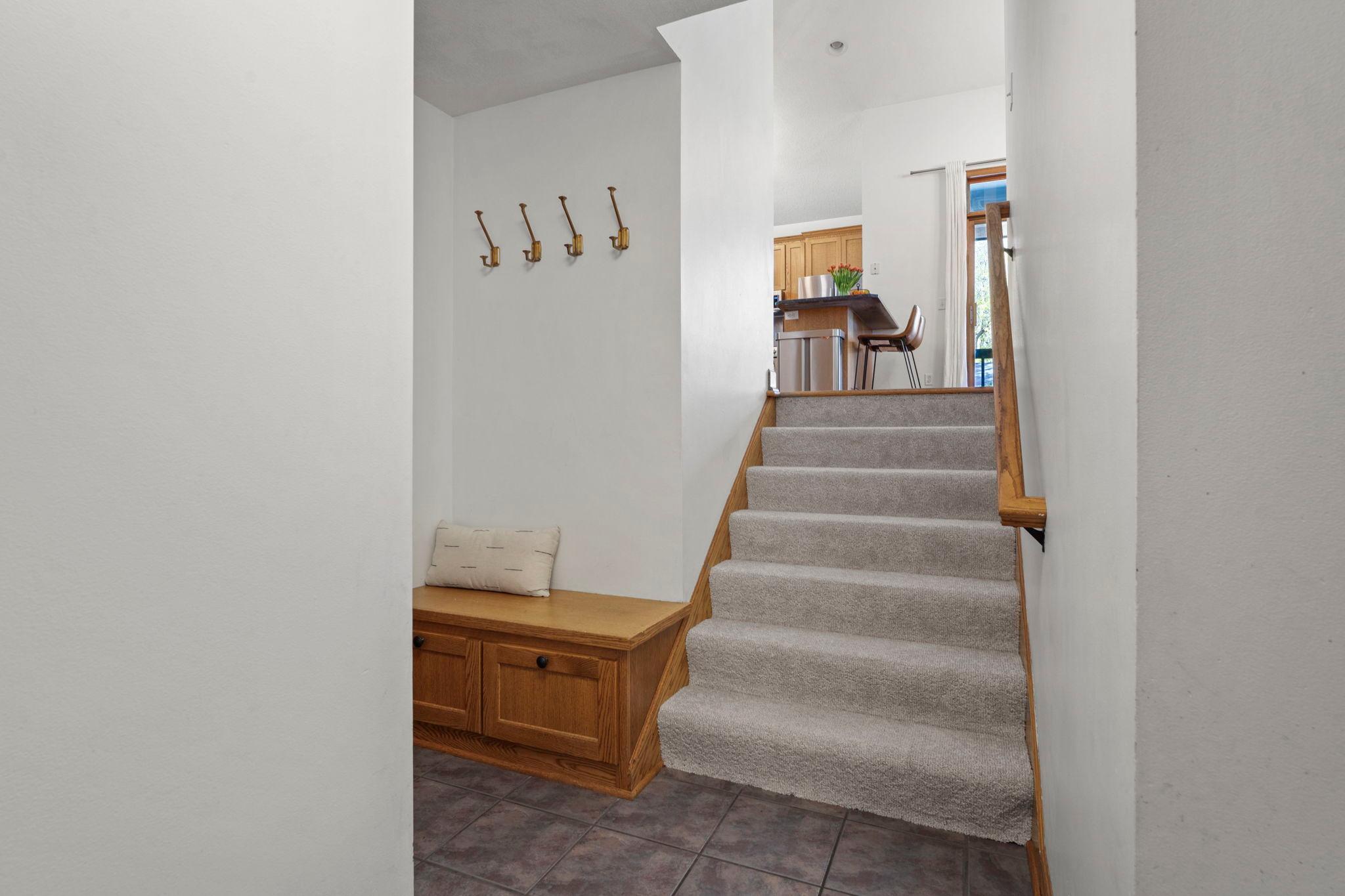 One level down from the main is the drop zone off the 3 car garage, also featuring a good sized coat closet (not shown) Note ceramic floors and new carpet