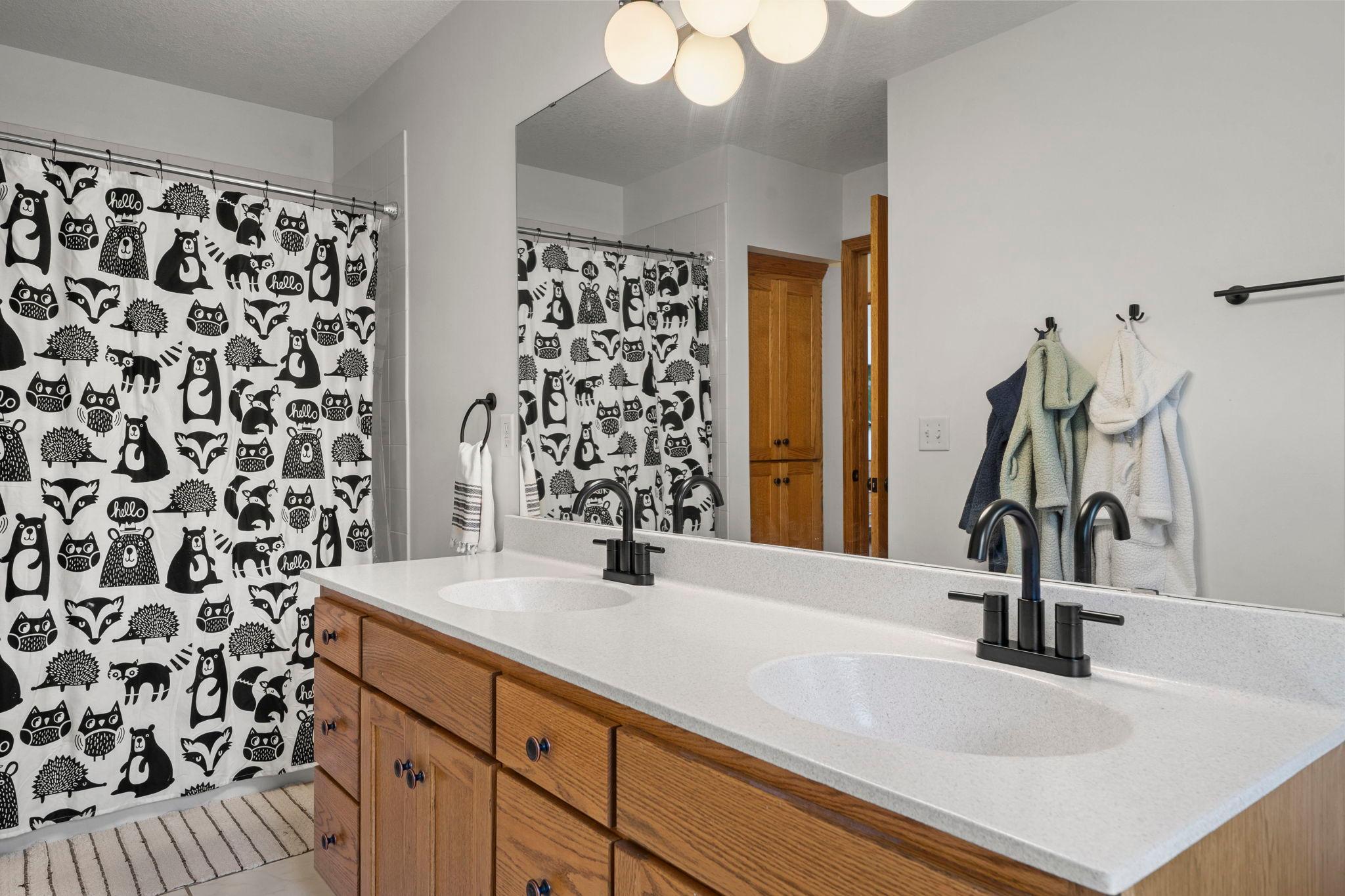 Full bath upstairs features double sink and large vanity