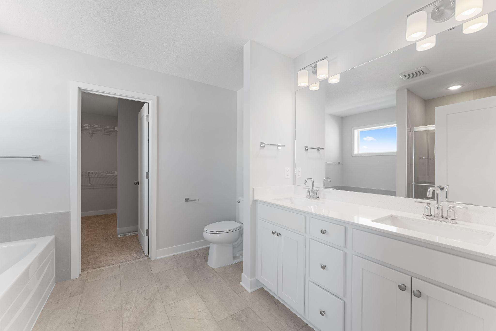 Owner's Suite Bathroom and First Walk-In Closet