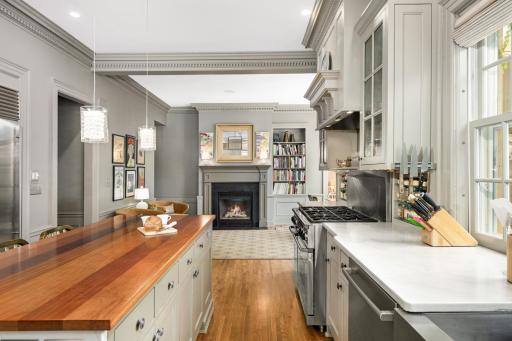 Quartz countertops in the main kitchen with center island featuring South American wood.