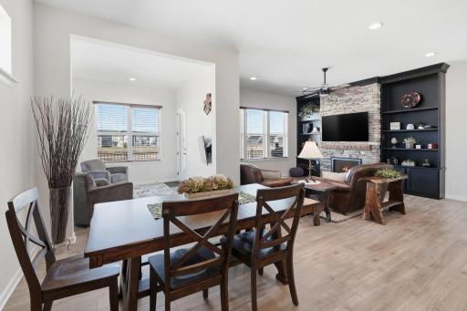 Open, Bright Living, Dining & Sunroom great for entertaining. Stone, Gas fireplace w/built-ins, LVP floors & ceiling fan.