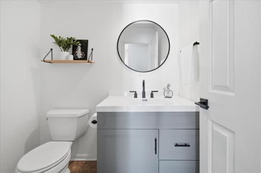Updated half bathroom on the main level with newer vanity, mirror, fixtures and faucet.