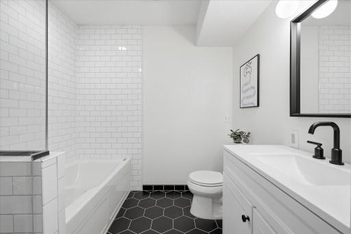 Upper level completely remodeled full bathroom! Lovely, tiled flooring, a new vanity, mirror, facet and fixtures.
