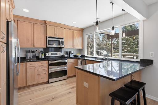 The kitchen features newer cabinetry, granite countertops, recessed lighting and stainless-steel appliances. Refrigerator and dishwasher are less than five years old.