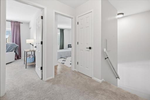 Upper level hallway area with linen closet. All of the door hardware throughout the home has been updated.