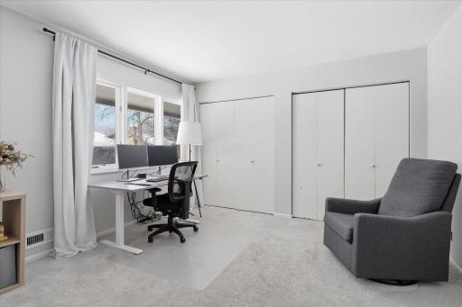 Plenty of space within the primary bedroom for an office area, reading, nook, etc. There are hardwood floors underneath the carpet in this room.