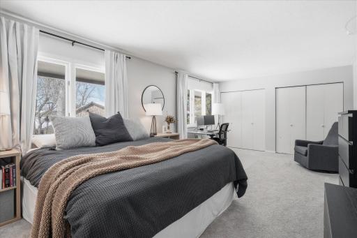 The primary bedroom has two big window and two closets.